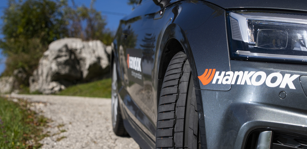Close up of a car adorned with Hankook stickers on the bumer and doors